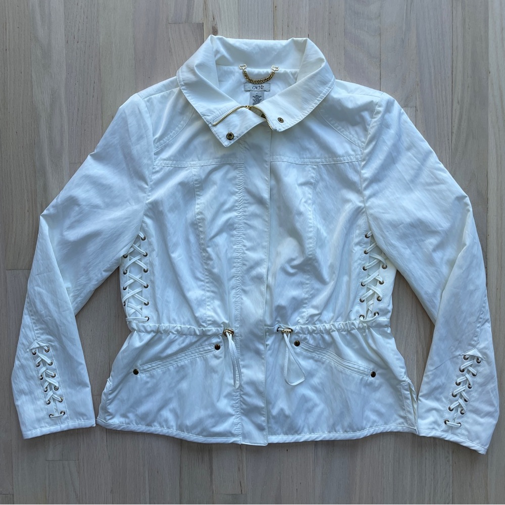 White lightweight rain jacket with lace up detailing cinched waist and zip